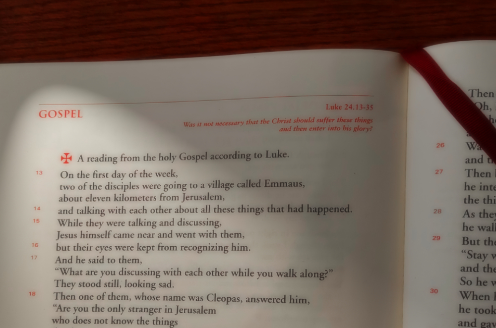 Gospel text blurred
